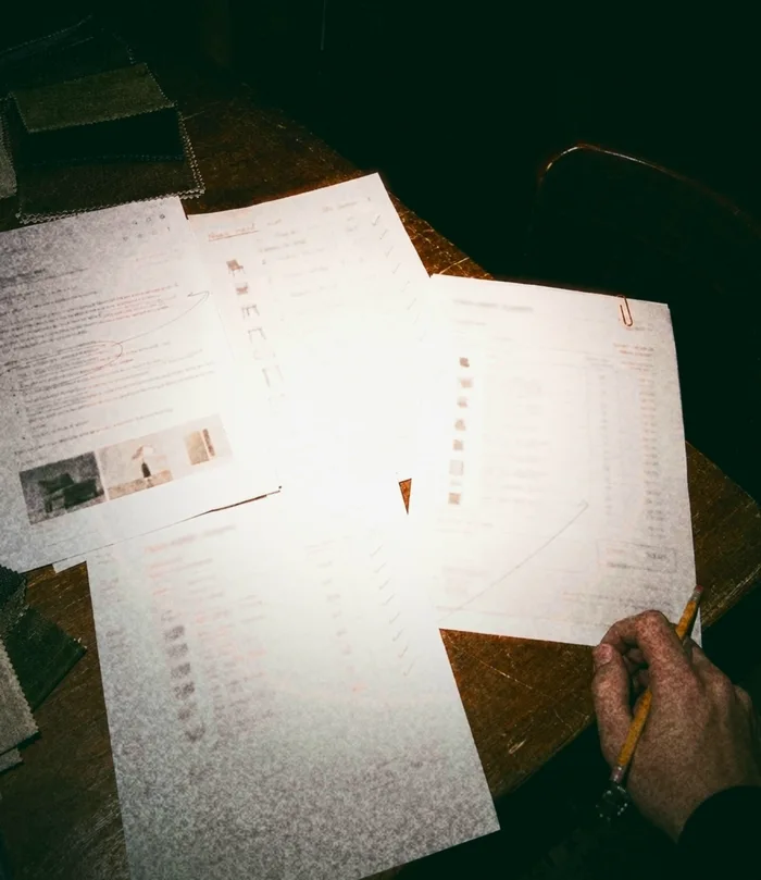 Seen from above, one wholesale order’s email, order form, packing list and invoice laid out on a table and linked in pencil